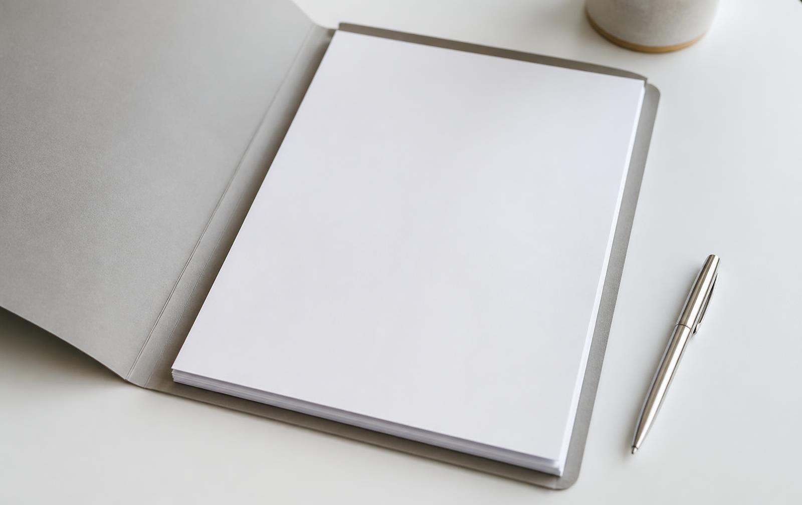 Folder with printed compliance documents on a desk